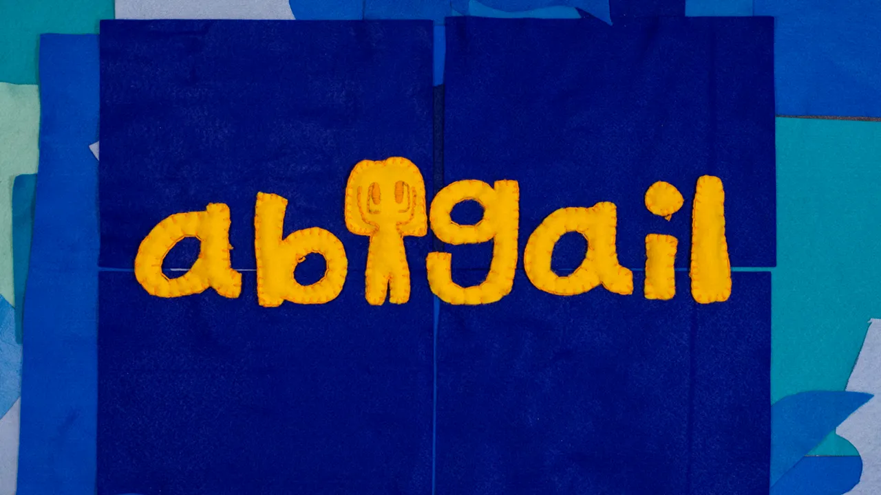 Abigail written in yellow felt letters across a blue felt background